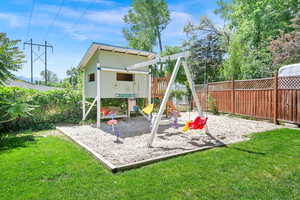 View of jungle gym/swing set and sand box