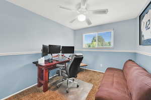 Office (or bedroom) with carpet flooring, baseboards, and a ceiling fan