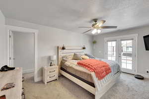 Bedroom with access to outside, light colored carpet, french doors, baseboards, and a textured ceiling