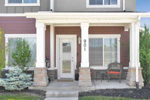 Entrance to property featuring covered porch
