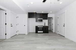 Kitchen featuring appliances with stainless steel finishes, baseboards, ceiling fan, recessed lighting, and light wood-style flooring