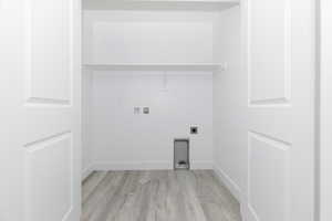 Laundry room featuring hookup for an electric dryer, light wood-style flooring, washer hookup, and baseboards
