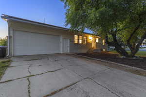 Ranch-style house with driveway, a garage, and brick siding