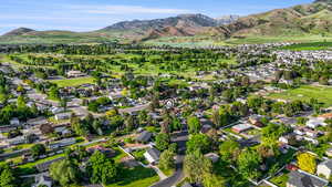View of property location with mountains and nearby suburban area