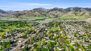 Aerial view of property's location featuring mountains and nearby suburban area