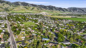 Aerial overview of property's location with mountains and nearby suburban area