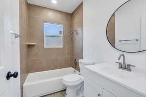 Bathroom featuring vanity, shower / washtub combination, toilet, and wood finished floors
