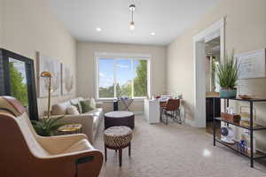 Sitting room featuring carpet, baseboards, and recessed lighting