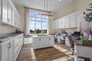 Home office with wood finished floors, recessed lighting, a sink, and a chandelier