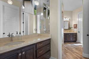 Full bath featuring wood finished floors and vanity