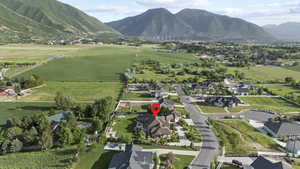 Aerial view of property's location featuring mountains and nearby suburban area