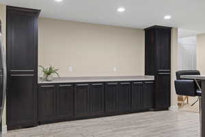 Kitchen with light countertops, recessed lighting, and light wood-type flooring