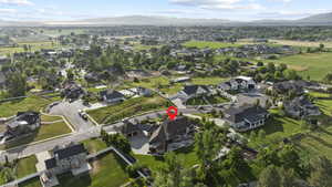 Aerial view of property's location featuring mountains and nearby suburban area