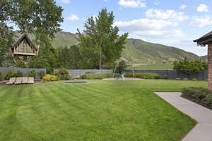 View of yard with a mountain view and a playground