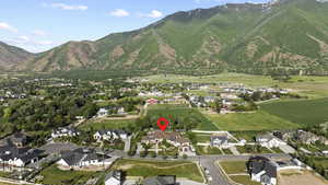 View of property location featuring mountains and nearby suburban area