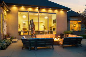 Patio terrace at dusk featuring an outdoor living space and a patio