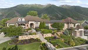 View of front of house with stone siding, a mountain view, and stairs