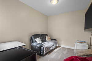 Living area featuring carpet and baseboards