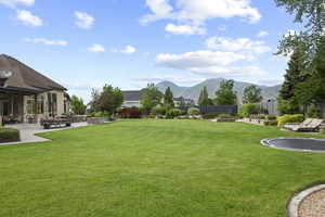 Surrounding community with a mountain view and a patio area