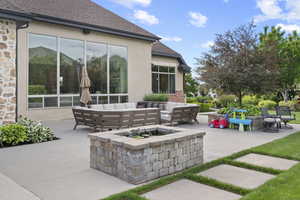 View of patio with an outdoor living space with a fire pit