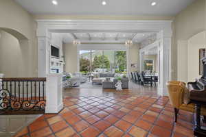 Living room with recessed lighting, beam ceiling, tile patterned flooring, and a fireplace