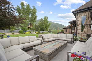 Fenced backyard with a mountain view, outdoor lounge area, and a patio area
