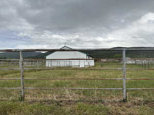 View of yard with a rural view, a pole building, and an outdoor structure
