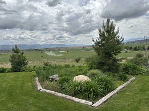 View of yard with a rural view and a mountain view