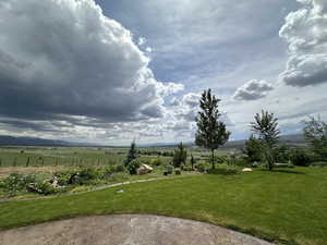 View of yard with a rural view and a mountain view