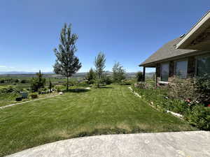 View of grassy yard featuring a mountain view