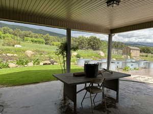 View of patio featuring outdoor dining space, a mountain view, and area for grilling