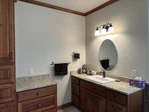 Bathroom featuring vanity and ornamental molding