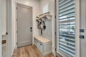 Mudroom featuring light wood-style floors