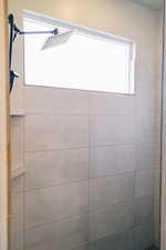 Full bathroom featuring tiled shower