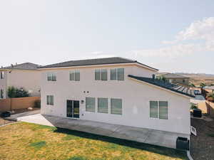 Rear view of house featuring a patio, a tile roof, stucco siding, and central air condition unit