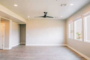 Unfurnished room featuring light wood-style floors, a ceiling fan, recessed lighting, and baseboards