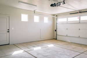 Garage featuring a garage door opener