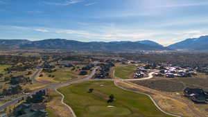 Aerial overview of property's location featuring a mountain backdrop and nearby suburban area