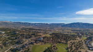 View of mountain background featuring a golf club and nearby suburban area