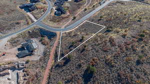 Aerial view of property and surrounding area with property parcel outlined and a desert landscape