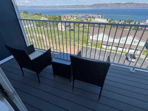 Wooden terrace featuring a water and mountain view
