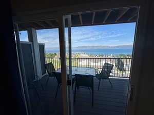 Balcony with a water view and outdoor dining area