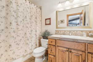 Full bath featuring vanity, toilet, tile patterned flooring, and a shower with shower curtain