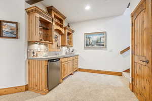 Indoor wet bar with refrigerator, light carpet, baseboards, and recessed lighting
