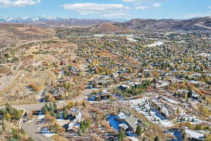 Aerial overview of property's location with a mountain backdrop and nearby suburban area