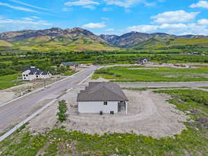Aerial view of property and surrounding area featuring mountains