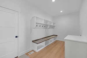 Mudroom featuring light wood-style flooring, baseboards, and recessed lighting