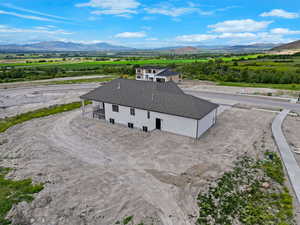 Aerial view of property and surrounding area featuring mountains