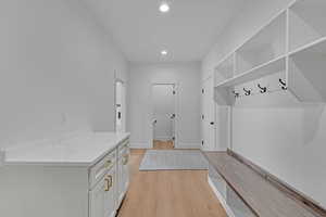 Mudroom with recessed lighting and light wood-type flooring