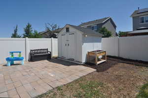 Fenced backyard with a patio